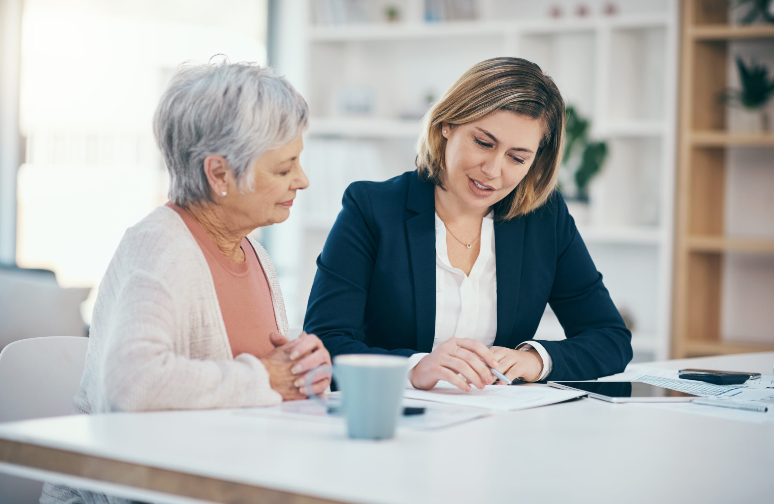 two females Retirement planning together at a table